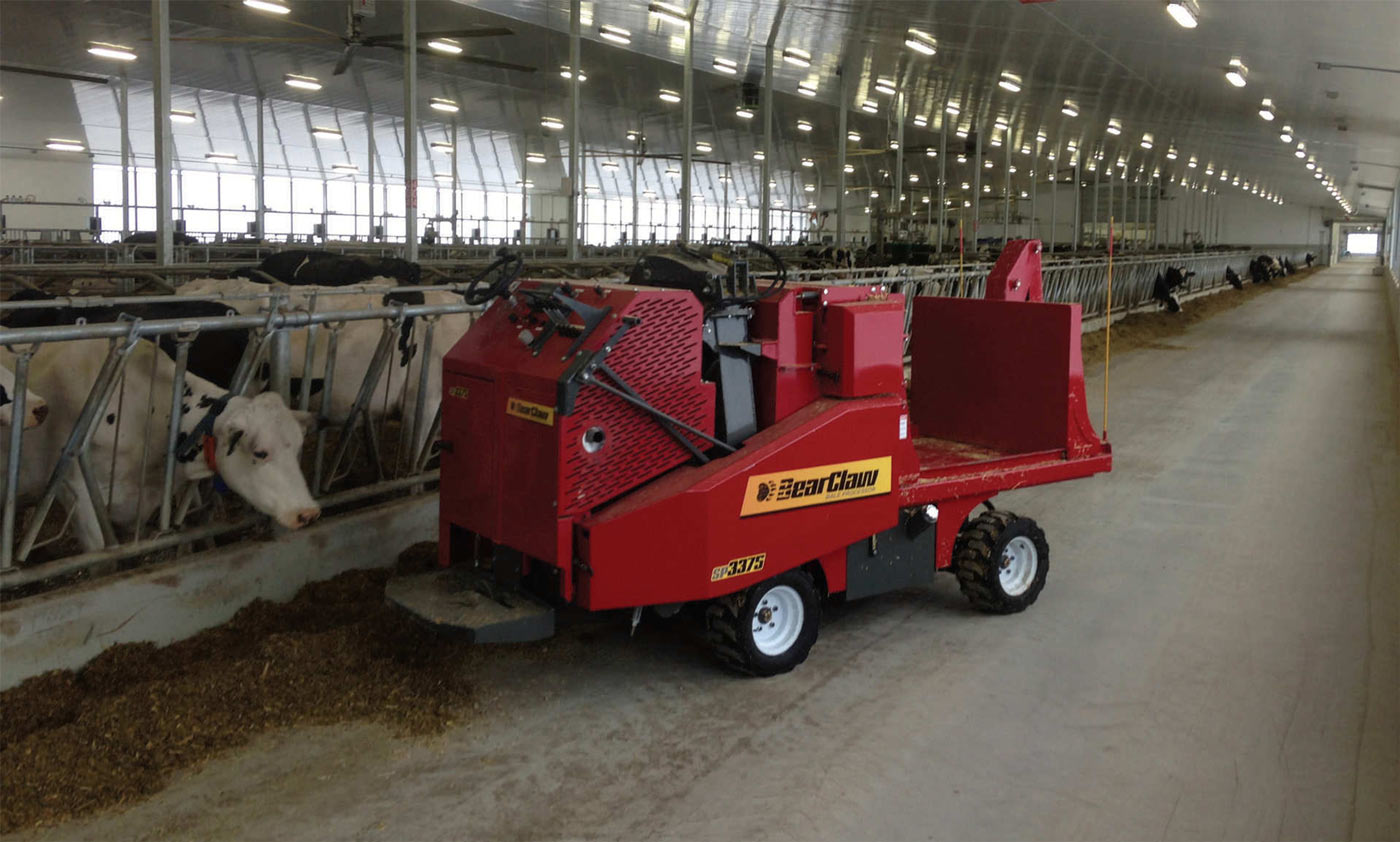 BearClaw SP3375 bale shredder working in a dairy barn